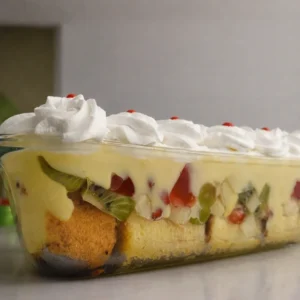 Homemade fruit trifle layered with sponge cake and fresh fruits available in Lahore.