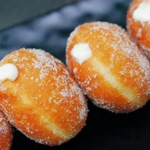 Soft homemade sugar coated coconut filled donuts filled with fresh cream available for delivery in Lahore.