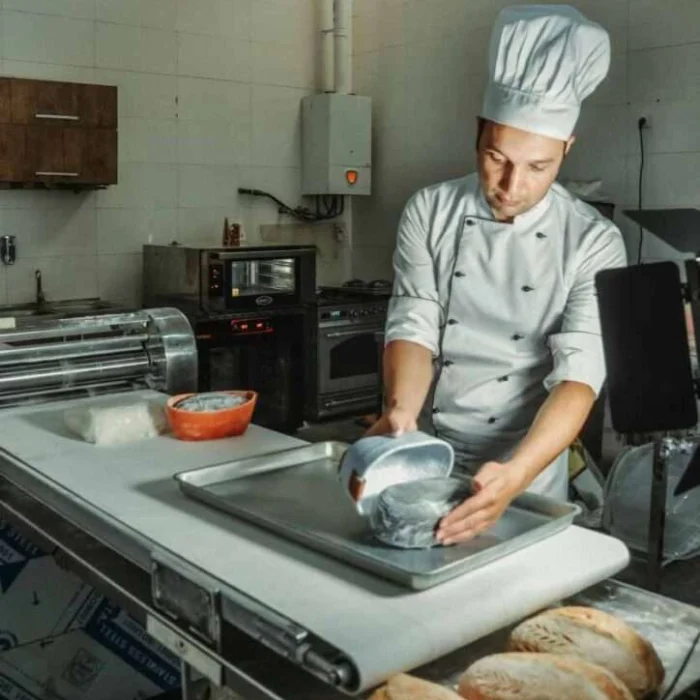 Bakery chef preparing fresh homemade cake in professional kitchen Lahore