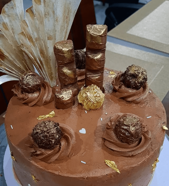 Homemade Ferrero chocolate cake topped with premium chocolates and creamy frosting freshly baked in Lahore