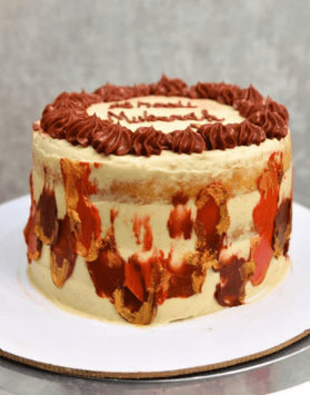 Homemade pistachio caramel cake in Lahore with creamy layers and caramel swirl topping on cake base.