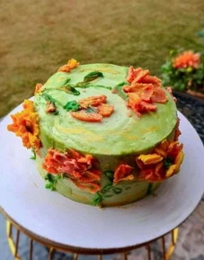 Custom designed homemade celebration cake in Lahore with floral buttercream decoration and premium finish.